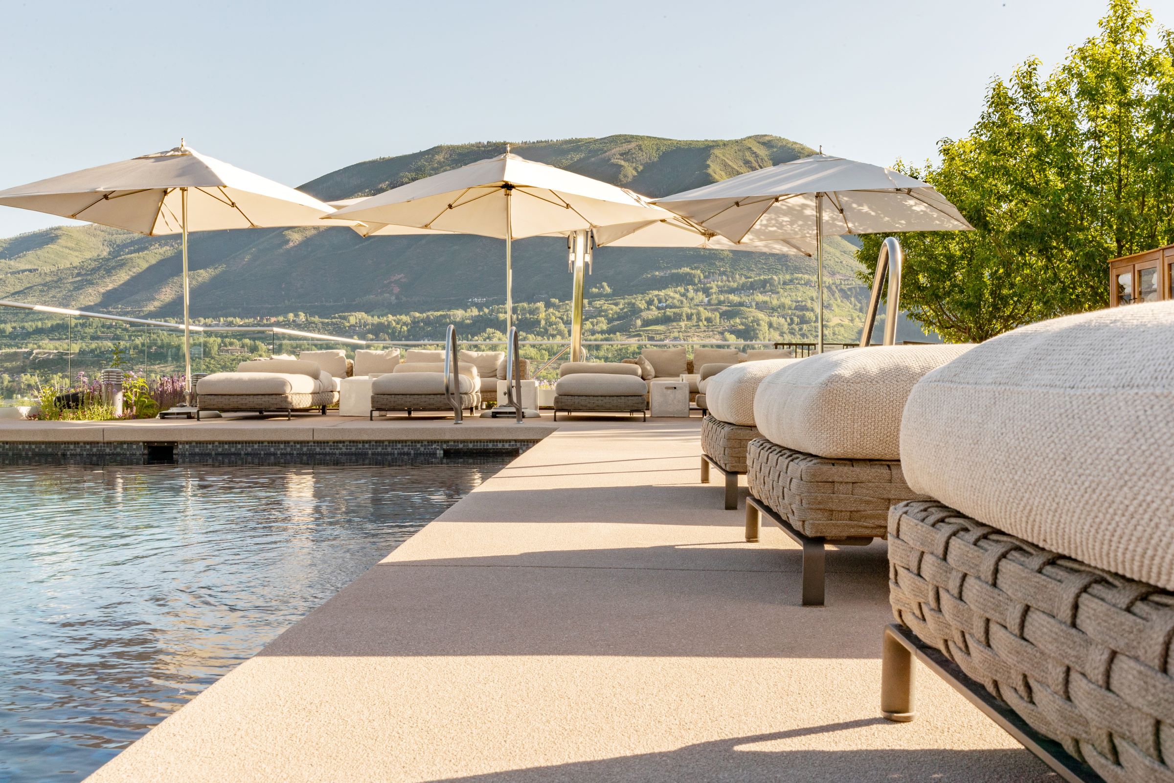 Poolside lounge chairs with scenic view in Aspen.