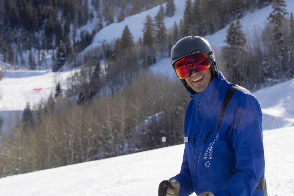 Mike Kaplan skiing and smiling.