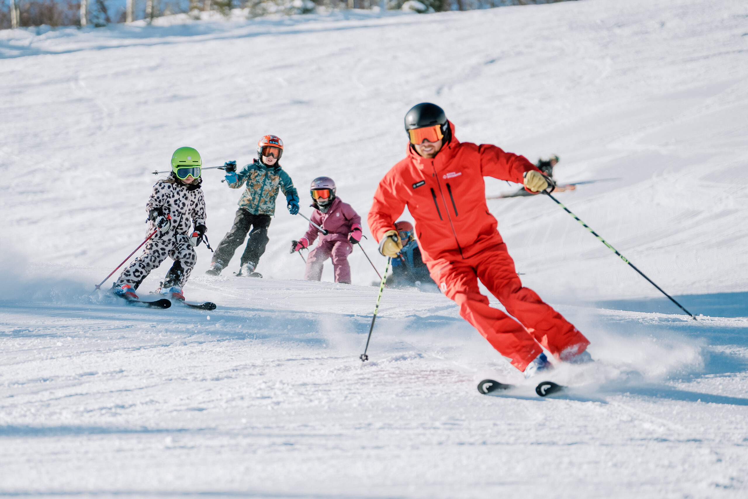 Ski pro at Aspen Snowmass with a group of kids in a ski lesson